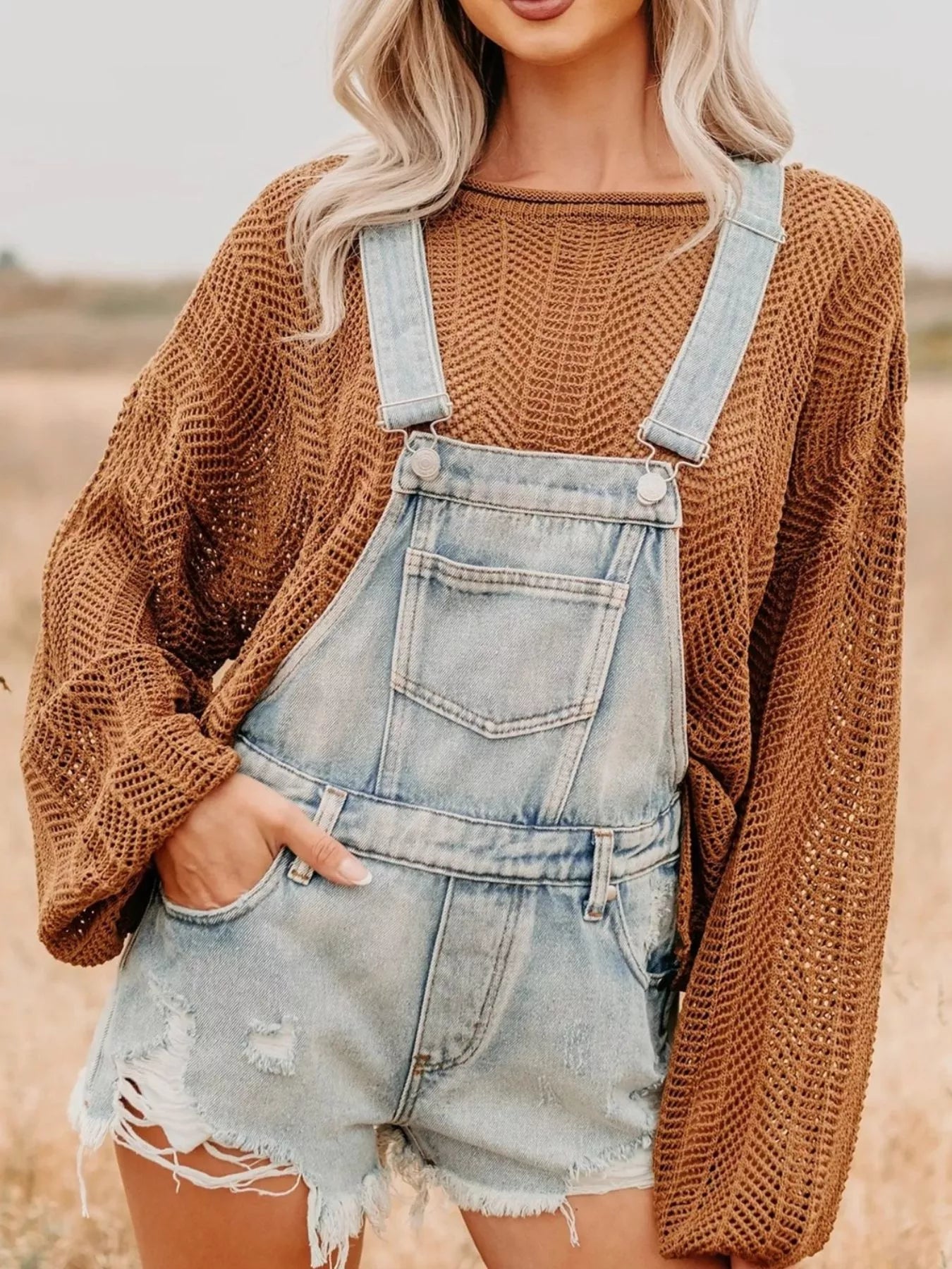 Distressed denim overalls shorts in light-wash with frayed hem