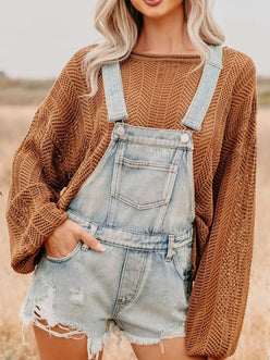 Distressed denim overalls shorts in light-wash with frayed hem