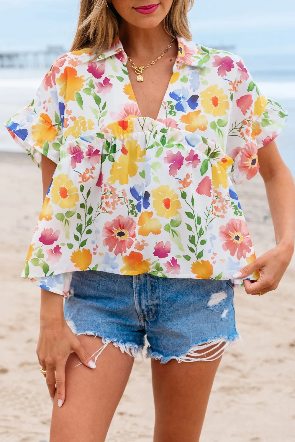 Floral boxy fit ruffled short sleeve blouse with vibrant blossoms
