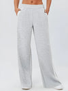 Gray heathered wide-leg sweatpants with white side stripes and pockets