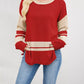 Red and beige color block knit sweater with side slits and striped sleeves