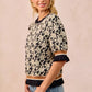 Black and cream floral BiBi textured rose knit top with ruffled cuffs