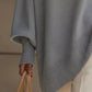 Light gray soft-knit womens oversized batwing sleeve poncho with ribbed cuffs