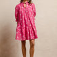 Vibrant pink BiBi short-sleeve dress with white palm trees, ruffles and scallops