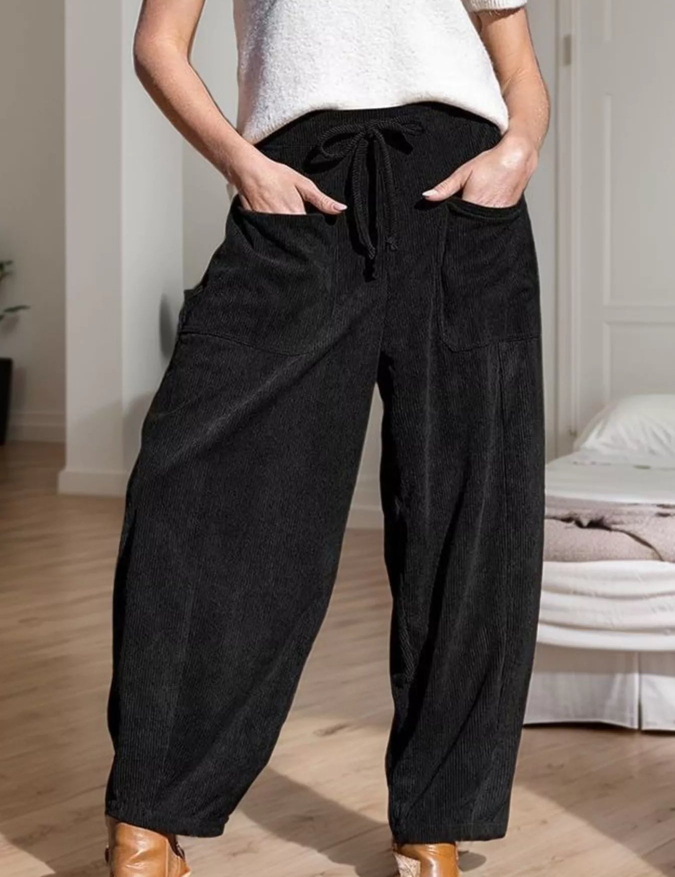 Black corduroy wide-leg pants with drawstring waist and pockets