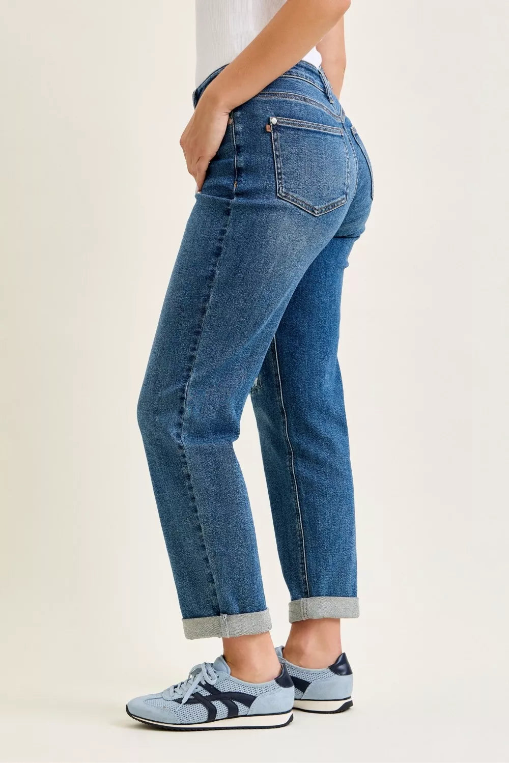 Judy Blue mid-rise boyfriend jeans in mid-wash blue with rolled cuffs and embroidered repair patch