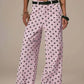 Daverri Polka Dot Wide Leg Jeans in light pink with black polka dots and belt