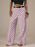 Daverri Polka Dot Wide Leg Jeans in light pink with black polka dots and belt