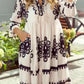 White embroidered Tassel Hem 3/4 Sleeve Mini Dress with black floral patterns