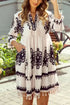 White embroidered Tassel Hem 3/4 Sleeve Mini Dress with black floral patterns
