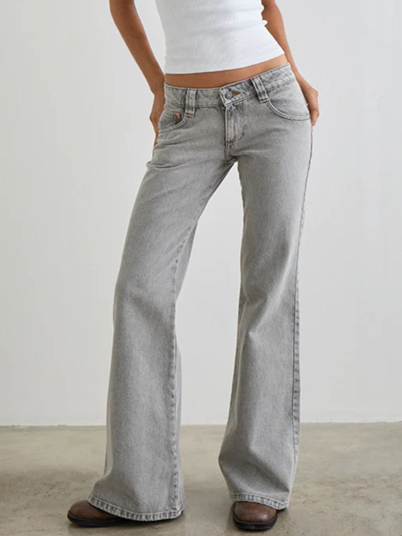 Low rise light-wash denim flare jeans with five-pocket design and thigh fading