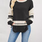 Black and cream color block side slit sweater with ribbed details