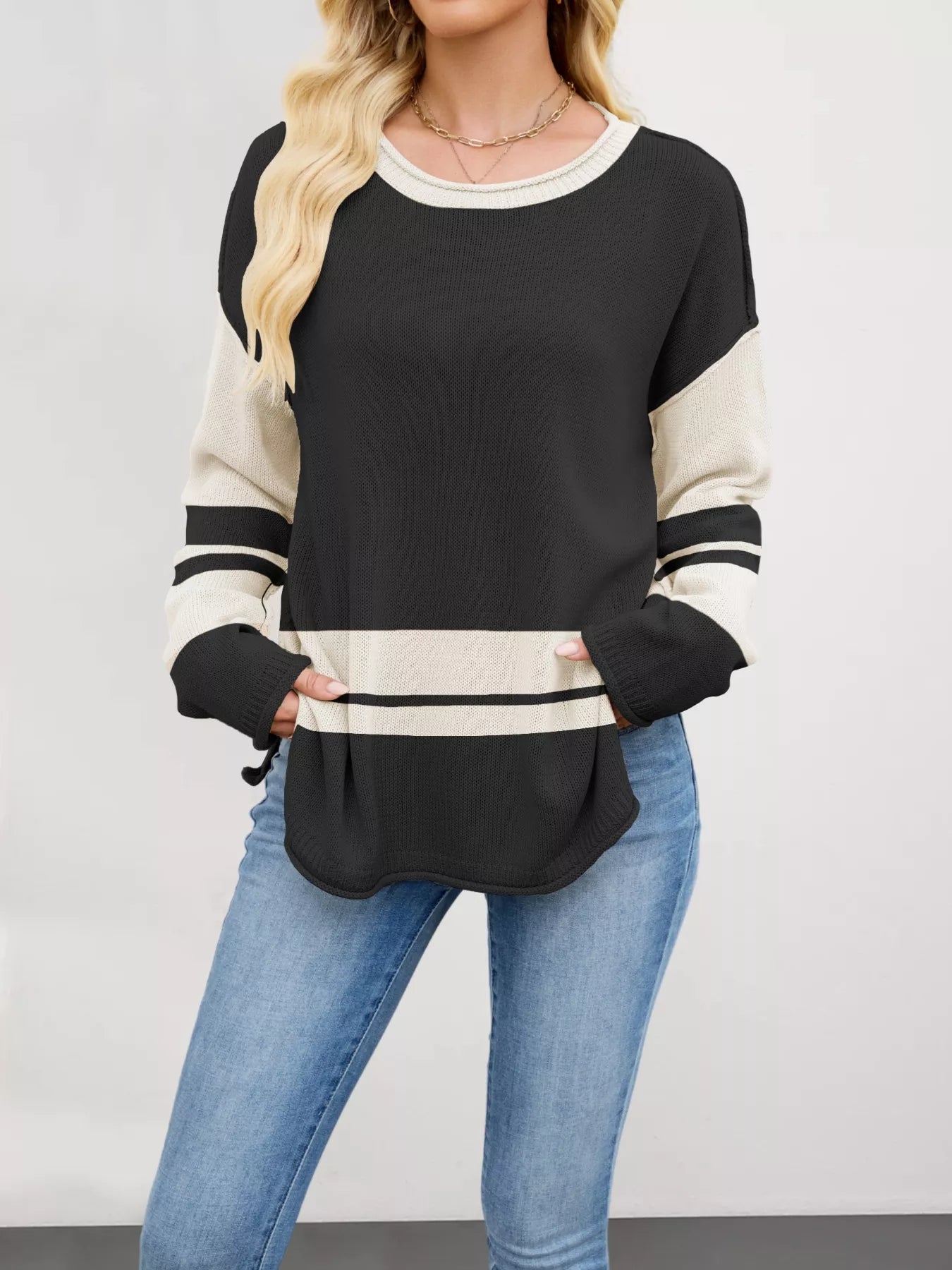Black and cream color block side slit sweater with ribbed details