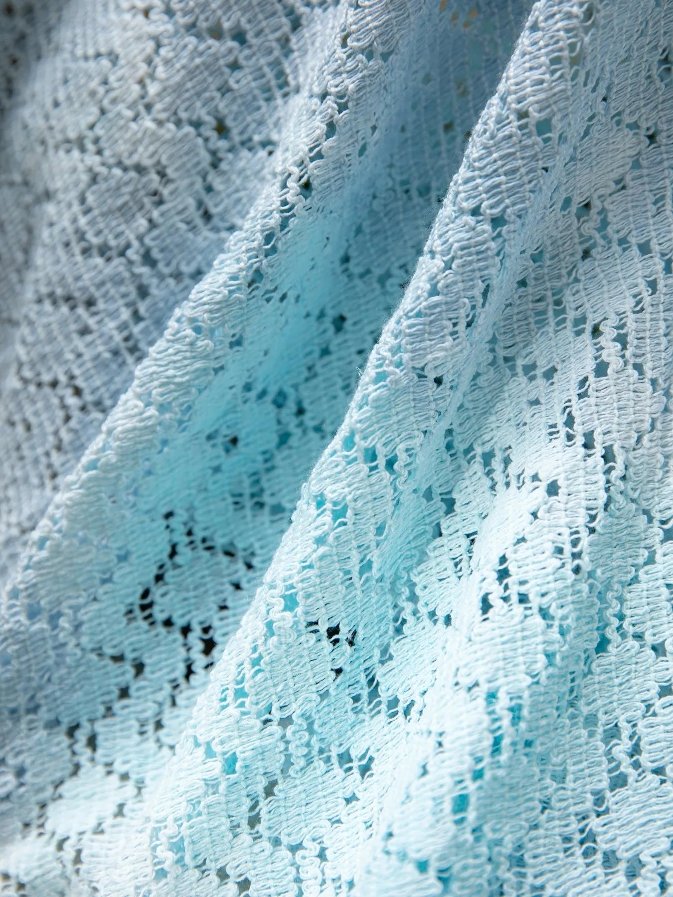 Daverri openwork tassel gradient knit cover up in light blue lace with floral patterns