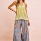 Light green ruffled halter top with textured fabric over BiBi floral pants