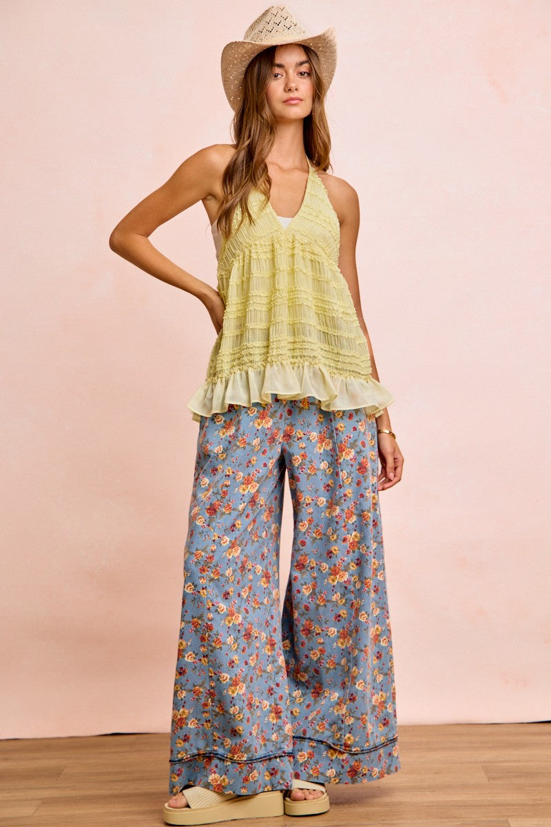 Light green ruffled halter top with textured fabric over BiBi floral pants