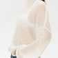 Boat neck dropped shoulder sweater in loose off-white knit with sheer texture and wide sleeves
