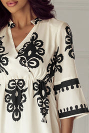 Cream and black floral wrap dress with bell sleeves
