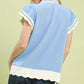 Umgee light blue short-sleeved blouse with white scallop trim and navy dots