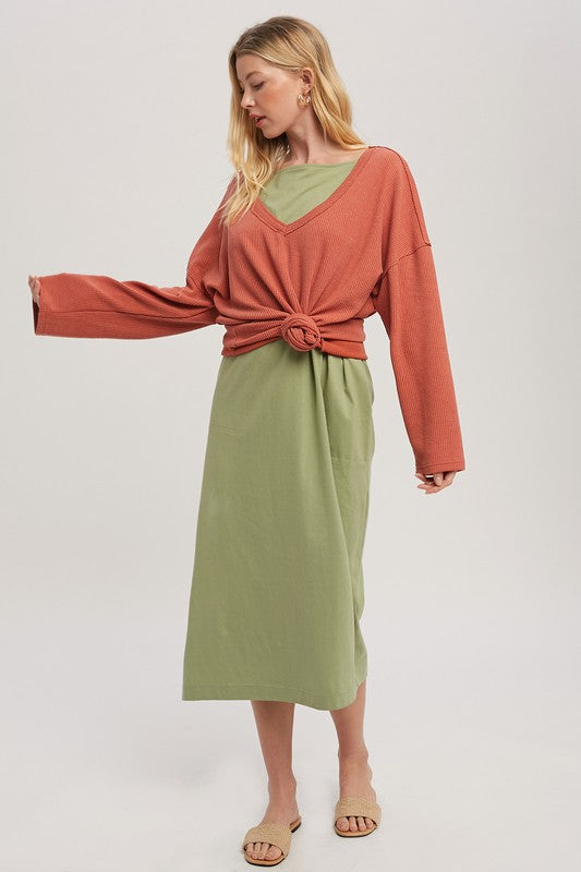 Woman in Casey Top: rust ribbed knit with green v-neck over olive midi skirt