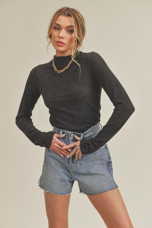 Black ribbed knit long-sleeve turtleneck top by Aemi + Co