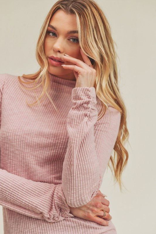 Soft pink ribbed knit Aemi + Co turtleneck dress with ruched cuffs