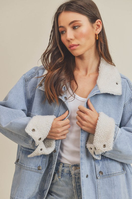 Light blue Aemi + Co denim jacket with white shearling collar and cuffs