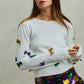 White SO ME Mardi Gras glitter bow knit sweater with gold purple sequins