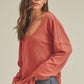 Cozy rust-colored ribbed knit Casey Top with relaxed fit and wide sleeves