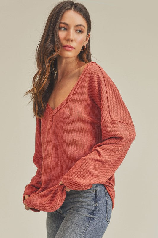 Cozy rust-colored ribbed knit Casey Top with relaxed fit and wide sleeves