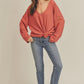 Casey Top: coral ribbed knit v-neck sweater with tied waist
