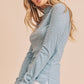 Light blue ribbed knit Aemi + Co mock neck top with ruched cuffs