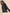 Black corduroy jacket worn by a person on a beige background