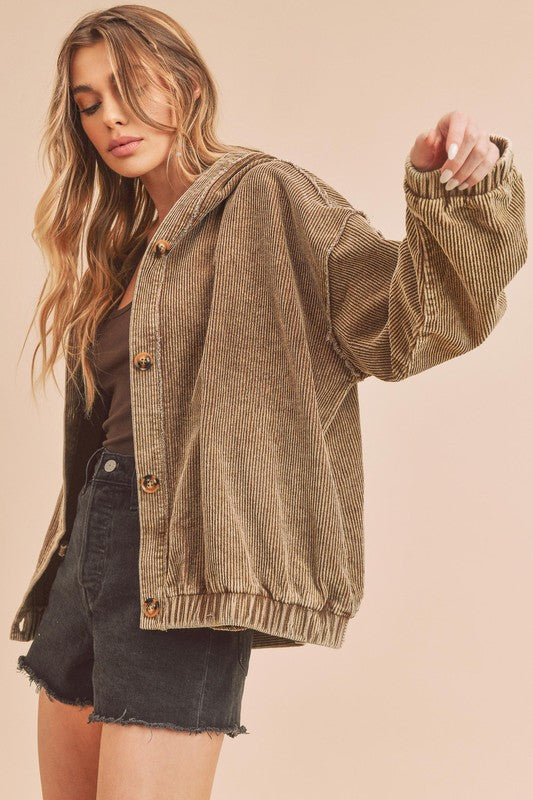 Woman wearing a brown corduroy jacket on a beige background