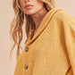 Cozy mustard-yellow Aemi + Co knitted cardigan with brown buttons