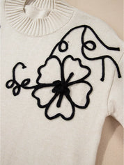 Flower Stitching Mock Neck Sweater in white with black floral embroidery