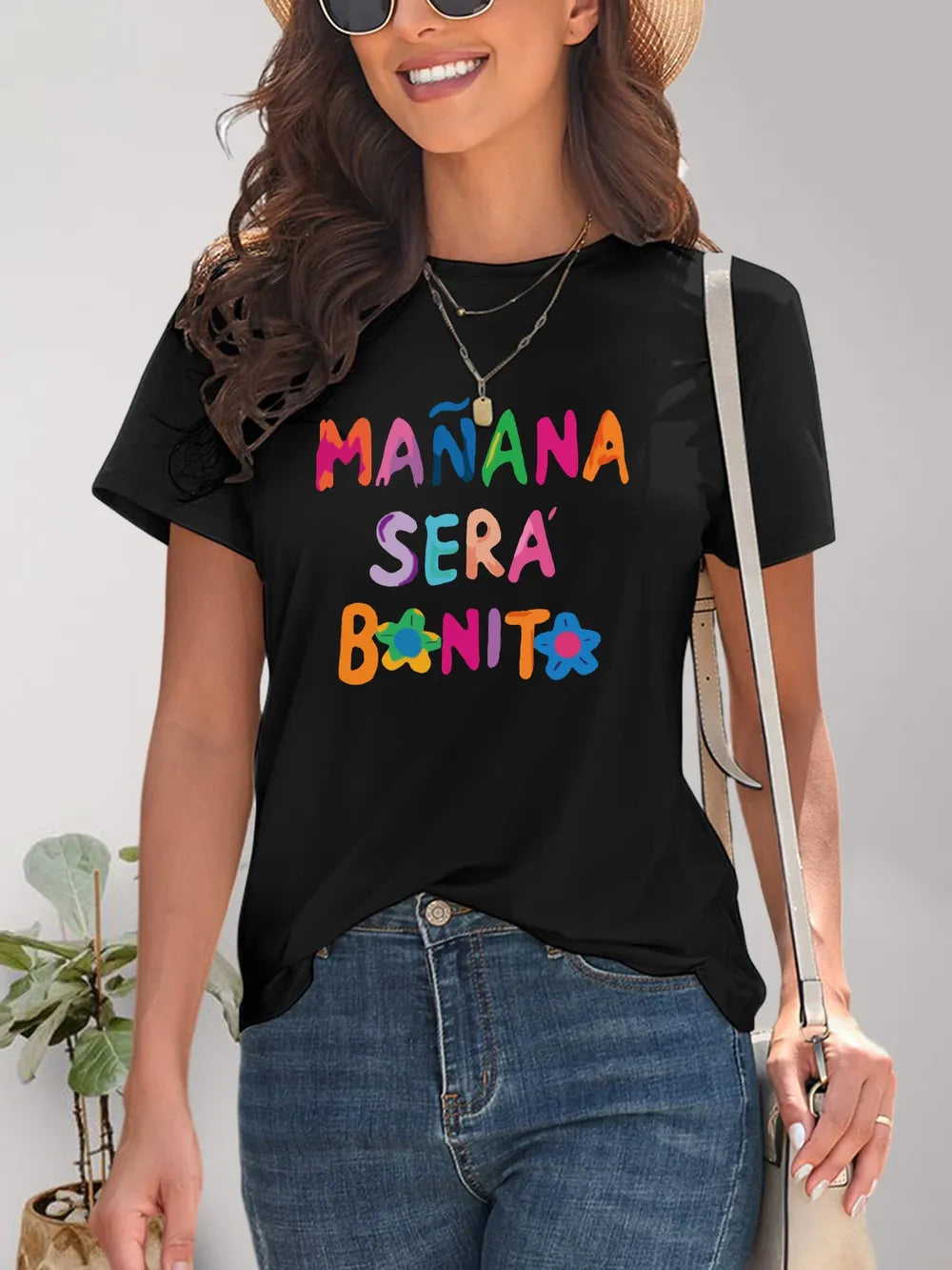 Black short-sleeved t-shirt with colorful manana sera bonito text and flowers