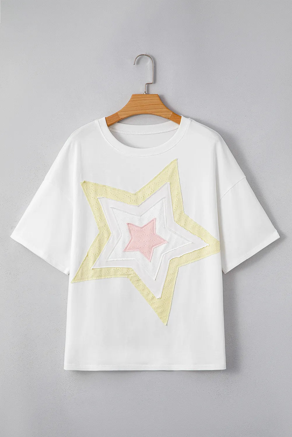 White drop shoulder tee with layered star applique in yellow and pink