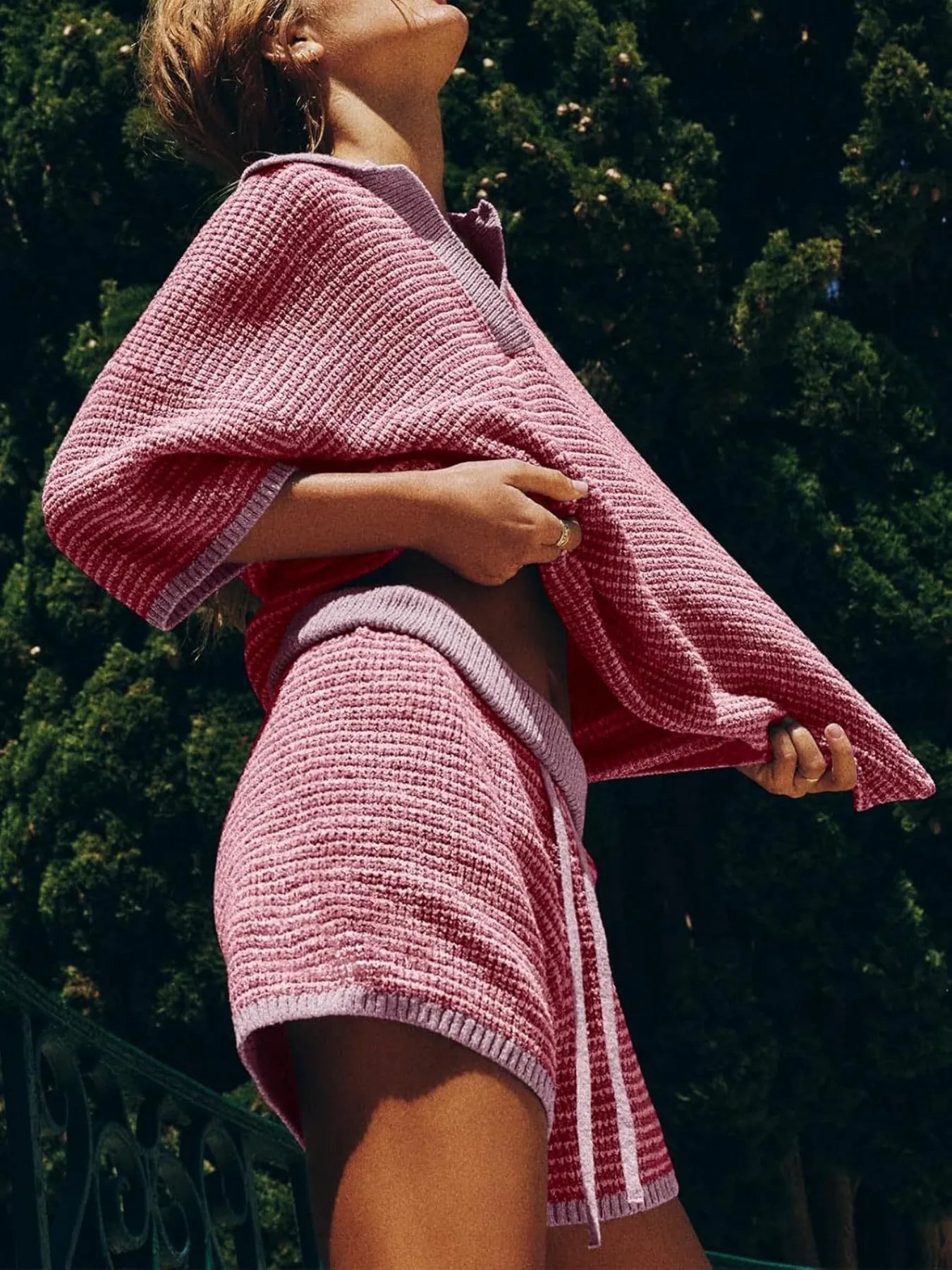 Pink waffle-knit women’s collared top and shorts set with white trim