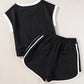 Black textured knit two-piece set with white contrast trim on sleeves, hem and sides