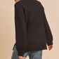 Black fuzzy knit sweater with side slit hem and mock neck by Aemi + Co