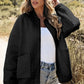 Women’s black quilted bomber jacket with floral textured pattern