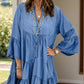 Blue denim tiered dress with notched flare sleeves and v-neckline