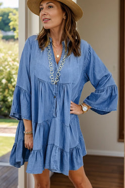 Blue denim tiered dress with notched flare sleeves and v-neckline