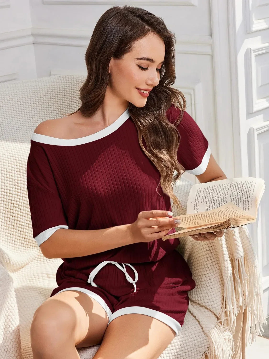 Maroon off-the-shoulder ribbed knit pajama set with white trim and drawstring shorts.