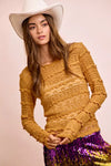 Mustard yellow ruffled sweater with white wide-brimmed hat