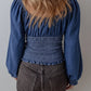Blue denim blouse with puffed sleeves and smocked waistband