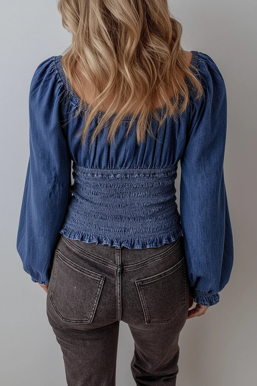 Blue denim blouse with puffed sleeves and smocked waistband