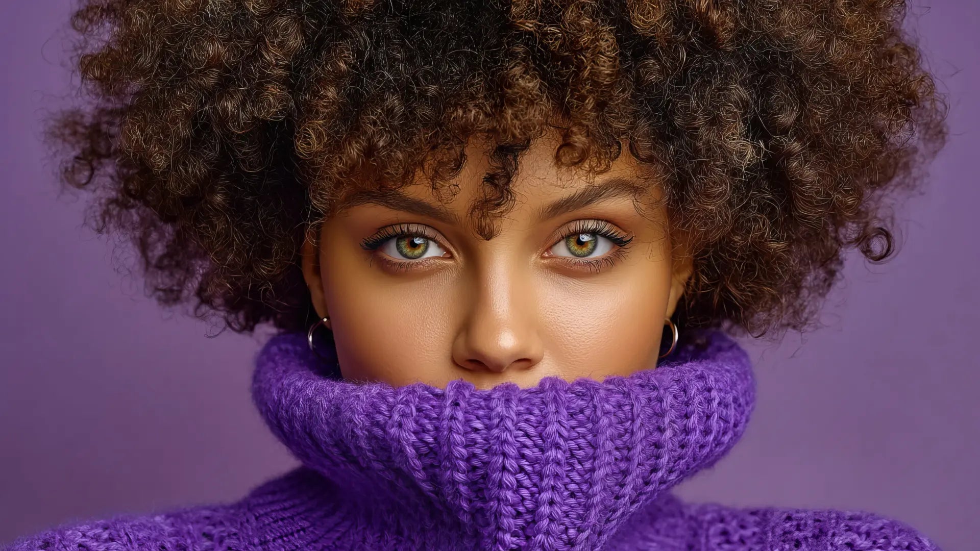 Woman wearing a purple knitted sweater with a textured background