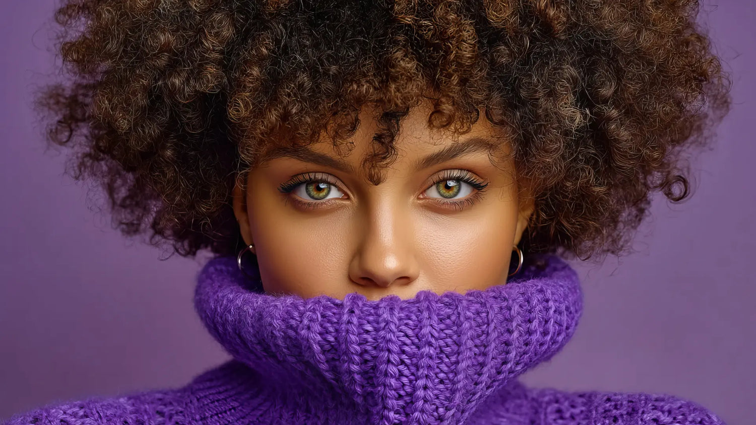 Woman wearing a purple knitted sweater with a textured background